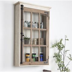 a wooden cabinet with glass doors on the wall