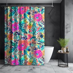 a colorful shower curtain in a bathroom with marble flooring and walls, along with a plant