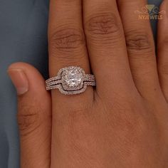 a woman's hand with a diamond ring on it and two bands around the band