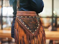 Do you want a bohemian style? with our stunning hobo fringe leather bag, expertly crafted from high-quality sheepskin leather and decorated with cute fringe details with engraved hand tool leather. This hobo bag features a comfortable shoulder and cross body strap, making it perfect for both casual and any occasions.  Its unique design handmade bag not only adds a bohemian touch to any outfit, but will make you different with others. It's time to get this fringe bag on your closet or you can gif Bohemian Shoulder Bag With Tassels For Fall, Leather Fringe Hobo Bag For Festivals, Bohemian Fall Bags With Tassels, Traditional Fringe Bag, Festival Hobo Bag With Tassels, Artisan Brown Bag With Fringe, Brown Artisan Bags With Fringe, Artisan Brown Bags With Fringe, Bohemian Leather Hobo Bag For Fall