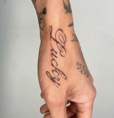 a person's hand with tattoos on it and the word love written in cursive writing