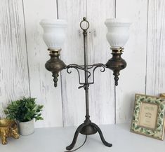 an old fashioned two light candle holder on a table