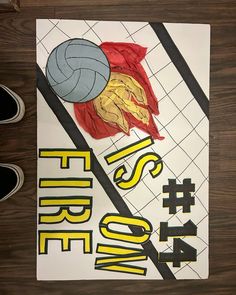 there is a poster on the floor that says fire zone with volleyball balls and net