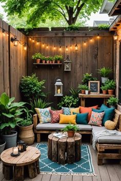 an outdoor patio with wooden furniture and potted plants