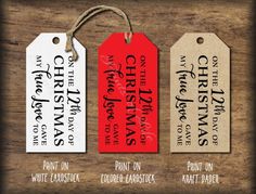 three christmas gift tags with the names of each holiday season on them, hanging from twine strings