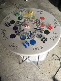 a game board sitting on top of a table covered in magnets and glass bottles