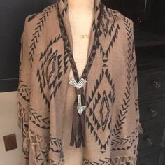 This Is A Great Aztec Vest With Fringe Detail And Convertible Collar That Also Can Be Worn Over The Head! See Last Photo! It Is A Beautiful Shade Of Taupe With Black Aztec Print. Originally Purchased For A Gift. Never Worn. Tags Attached. Arrow Necklace Not Included. Casual Brown Poncho For Festival, Brown One Size Poncho For Festival, Casual Brown One Size Poncho, Casual One Size Brown Poncho, Brown Fringe Poncho For Fall, Bohemian Brown Cape Outerwear, Brown Bohemian Cape Outerwear, Brown Fringed Poncho For Fall, Aztec Jacket Women