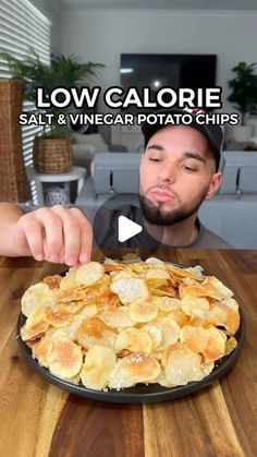 a man sitting at a table with a plate of food in front of him and the caption low calorie salt & vinegar potato chips