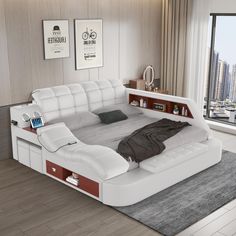 a bed that is in the middle of a room with a laptop on top of it