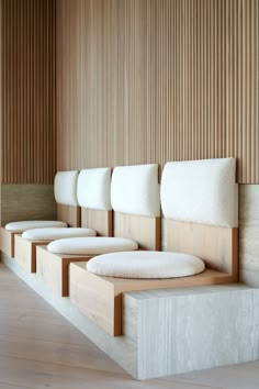 a row of white chairs sitting next to each other