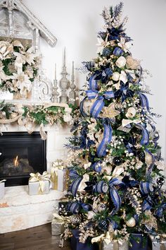 a decorated christmas tree with blue and gold ribbons