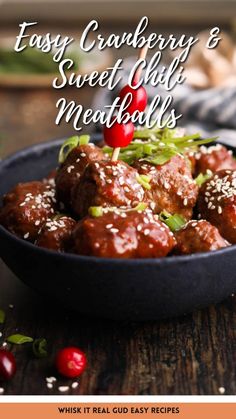 a bowl filled with meatballs and garnish on top of a wooden table