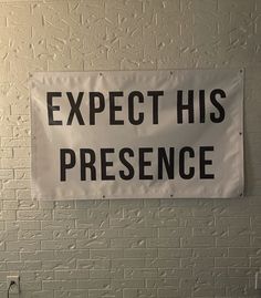 a sign that says expect his presence on the wall