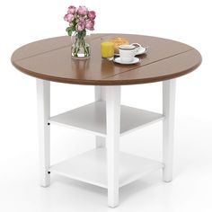 a white and brown table with some flowers on top of it next to a cup