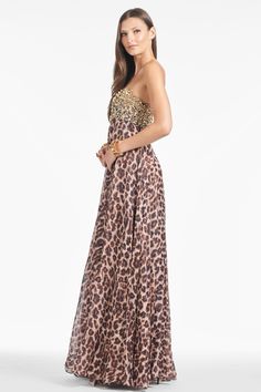 It's obvious upon first look: Ames is FIERCE. Where to start with this one? She's a full-length, strapless gown in our all-over leopard print. The bodice features gleaming gold embellishment that catches the light in all the right ways, while the big cat print cascades down in the most elegant, ethereal way. Prepare to turn heads with this statement piece.Details:Model is 5'10" wearing size 2Full-Length, 66" from top of shoulder to bottom hem46" Skirt LengthBack ZipperNo PocketsPrinted Silk Visc Elegant Leopard Print Maxi Dress For Evening, Diwali Dresses, Wedding August, Sachin Babi, Gold Embellishment, Strapless Gown, Fringe Skirt, Special Occasion Outfits, Luxury Dress