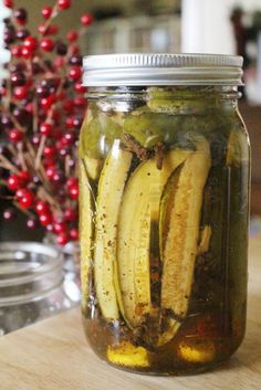 pickled bananas in a jar on a table