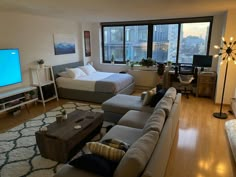 a living room filled with furniture and a flat screen tv