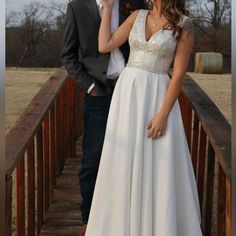 a man and woman are standing on a bridge