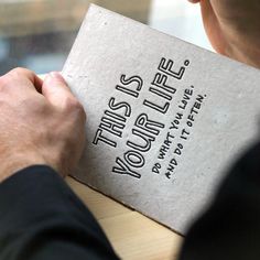 a man is holding a book that reads this is what life looks like on it