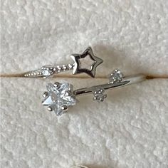 two silver rings with stars and diamonds on them