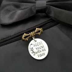 a close up of a luggage tag with a bow on it's side that says mom you're with me today