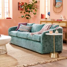 a living room filled with furniture and pink walls