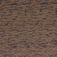 an orange, blue and brown carpet with some black spots on it's surface