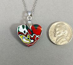 This fordite heart necklace is a great example of modern fordite. This piece is reversible with different colors on each side. The heart comes with a stainless steel bail and the pictured 20 inch stainless steel chain making it worry free jewelry. This fordite is from Ohio and occurred as a byproduct of painting parts for freightliners. This heart measures about 20 x 21 mm. Fordite is recycled automotive paint sourced from automotive factories as well as manufacturers who paint parts for new vehicles. It forms in thin layers as car parts are painted on the racks that hold them in place. After hundreds of trips through the booth where the paint is sprayed and then baked the excess buildup is scraped off the racks. We buy this waste paint in rough chunks and recycle it into beautiful jewelry Fordite Jewelry, Chain Heart, Chain Making, Automotive Paint, One Inch, Agate Pendant, Valentine Heart, Beautiful One, Car Manufacturers