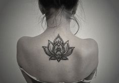 a woman with a lotus tattoo on her back