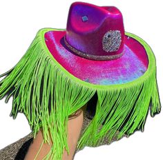 a woman wearing a purple hat with green fringes and a jeweled brooch