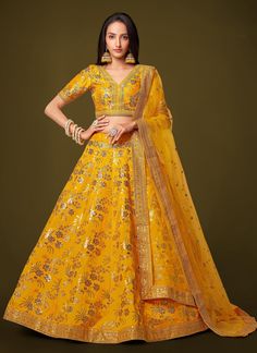 Indulge in luxury with our Designer Yellow Sequins Embroidered Slab Silk Lehenga Choli. Made for the sophisticated and exclusive woman, this exquisite lehenga choli is perfect for a reception or bridal wear. The yellow sequins and embroidery add a touch of glamour, making you the center of attention. Elevate your style with this premium piece. The unstitched blouse can be customized upto 46 inches. Do Note: All the accessories shown are for styling purpose only. Slight color variation may occur Brocade Sets With Meenakari For Reception, Brocade Meenakari Sets For Reception, Semi-stitched Brocade Lehenga For Reception, Designer Gold Choli With Meenakari, Wedding Brocade Sets With Meenakari Details, Fitted Traditional Wear With Meenakari For Reception, Diwali Reception Lehenga With Meenakari Detailing, Diwali Reception Lehenga With Meenakari, Fitted Brocade Lehenga With Meenakari Details