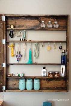 a wooden shelf filled with lots of jewelry