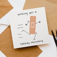 a card that says wishing you a speedy recovery next to some scissors and envelopes