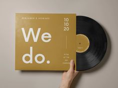 a person holding up a black and gold record with the words we do on it