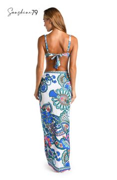 This pareo by Sunshine 79 features an elegant white and blue multicolored paisley print, exuding a blend of sophistication and playfulness. Its intricate pattern adds a touch of bohemian charm to your poolside style. This gorgeous pareo looks equally beautiful with a one-piece suit as it does a bikini top and bottoms. The sarong-style fit that ties at the side lends a chic silhouette. [split] Details Pareo cover up Adjustable side tie with tassels One size fits all Fabric 100% Rayon Crepe Bohemian Fitted Sarong For Vacation, White Bohemian Sarong For Spring, Bohemian White Sarong For Spring, Bohemian Patterned Swimwear For Spring, Spring Bohemian White Sarong, White Bohemian Sarong For Poolside, Bohemian Multicolor Sarong For Poolside, Bohemian Tropical Print Sarong For Pool, Bohemian Patterned Swimwear For Vacation