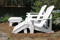 two white adironda chairs sitting next to each other