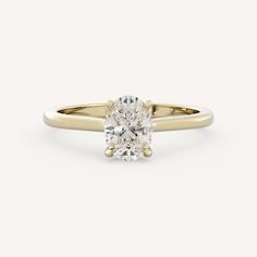 a yellow gold engagement ring with an oval cut diamond