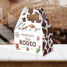 a brown and white cow print bag sitting on top of a counter