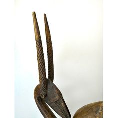 an animal statue with long horns and large beaks