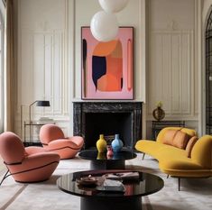 a living room filled with furniture and a fire place in the middle of the room