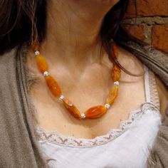 "This is a stunning statement necklace. Orange and light brown tone druzy agate stones create a very unique piece. Agate's most noticeable properties overall are balancing yin/yang energy, courage, protection, healing, and calming. Historically it was placed in water for cooking or drinking to dispel sickness. The Metaphysical and Healing Properties Lore of any specific type of agate depend to some extent on the color of the agate, but all agates have certain things in common. Agate is a stone o Orange Statement Necklace, Necklace Stones, Necklace Orange, Orange Necklace, Stones Necklace, Orange Agate, Necklace Stone, Druzy Necklace, Druzy Quartz