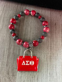 Sorority inspired gift set: bracelet. The bracelet is made with stretch cord. Casual Red Charm Bracelet Gift, Casual Charm Bracelet With Letter Beads For Gift, Casual Letter Beads Charm Bracelet As Gift, Casual Letter Beads Charm Bracelet, Casual Red Stretch Bracelet As A Gift, Casual Red Stretch Bracelet For Gift, Casual Red Stretch Bracelet As Gift, Set Bracelet, Gift Registry