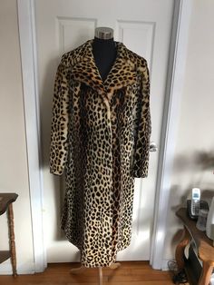 "This rare faux fur leopard print coat is long and just stunning! This authentic vintage leopard print coat was made in the late 1950s to early 1960s. The leopard print faux fur lays flat, and is super soft, thick, and shiny. This late 50s early 60s long leopard trapeze coat has full length sleeves, black leather trim at sleeves and pockets. It is lined in the most luxurious thick black satin! This amazing leopard print swing coat is so stunning! This is the kind of piece you pass down through g Cheetah Print Coat, Snow Leopard Fur Coat, Leopard Print Fur Coat, Vintage Leopard Coat, Leopard Print Faux Fur Coat, Luxury Women's Leopard Print Fur Coat, Luxury Leopard Print Faux Fur Coat, Leopard Print Coat, Fur Coat Vintage