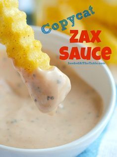 a close up of a bowl of food with a spoon in it and the words copycat zax sauce