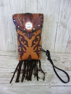 Crafted with a blend of rugged charm and western allure, these one-of-a-kind Leather Crossbody Hipster Purses are the epitome of cowgirl chic. Handcrafted from authentic cowboy boots, each purse exudes a sense of unique style that is perfect for those who embrace country fashion. The fringe detailing adds a touch of flair reminiscent of rodeo culture, making it a must-have accessory for any modern cowgirl. Whether you're hitting the town or attending a western-themed event, these purses effortlessly blend into your wardrobe, elevating your outfit with a dash of western chic. Embrace your inner cowgirl and make a bold statement with these stylish and versatile Crossbody Purses that are bound to turn heads wherever you go.  Cowboy Boot Crossbody Fringe Hipster Bag Handcrafted from Recycled C Purse With Fringe, Boot Purse, Totes Boots, Cowboy Boot Purse, Hipster Purse, Western Bag, Hipster Bag, Handpainted Bags, Painted Bags