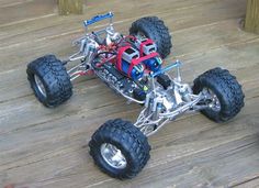 a toy truck with four wheels on a wooden floor