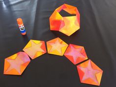 the paper stars are cut out and placed on the table next to each other with glue