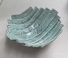 a set of six blue glass bowls sitting on top of a table next to each other