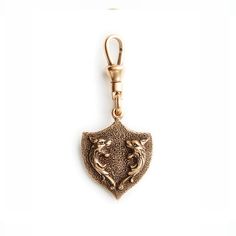 Royal Crest Charm by Fallen Aristocrat - The Paris Market Collectible Gold-tone Brass Jewelry, Luxury Collectible Bronze Jewelry, Antique Bronze Brass Jewelry, Antique Finish Brass Medallion Jewelry, Antique Yellow Gold Brass Jewelry, Antique Finish Yellow Gold Brass Jewelry, Historical Bronze Brass Jewelry, Bronze Historical Design Jewelry As A Gift, Heirloom Bronze Brass Jewelry