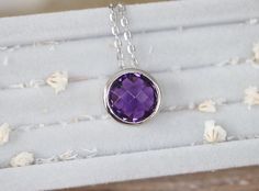 "A stunning collection of sliding necklace featuring a faceted Purple Amethyst handcrafted in sterling silver is a classic staple for any occasion. Belesas and 925 hallmarked on the outside pendant and suspended on a sterling silver 18\" chain. Wrapped in a box ready for gift giving. Necklace Info --------------------------------- Pendant measure 11.5mm Pendant Height with stone 7.5mm Chain Length 18\" Sterling Silver 925 High Quality Rhodium Plated to prevent tarnish --------------------------- Classic Amethyst Necklace For Gift, Sterling Silver Bezel-set Briolette Necklace, Sterling Silver Briolette Necklace With Bezel Setting, Sterling Silver Solitaire Necklace With Round Gemstone Pendant, Classic Purple Necklace For Gift, Faceted Sterling Silver Birthstone Necklace With Round Pendant, Sterling Silver Solitaire Gemstone Necklace, Amethyst Bezel Setting Jewelry Gift, Gift Amethyst Bezel-set Jewelry